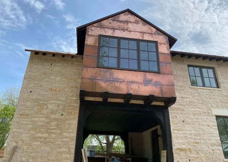 Copper metal panel facade on a stone building for Skylight Installation in Tavares