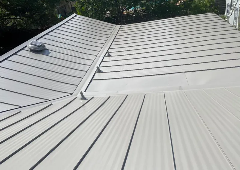 Solar attic fan installed on a metal roof for Roof Ventilation in Tavares